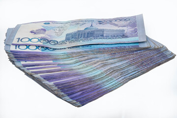 1 million Kazakhstani tenge in ten thousand banknotes on a white isolated background. - obrazy, fototapety, plakaty