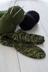 wool yarn, knitting needles and other tools for hand knitting.