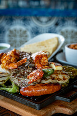 Parrillada de Sonora -Northern-style mixed grill with carne asada steak, mesquite chicken breast, chorizo links, spicy shrimp, Asadero cheese, cactus
paddles, grilled onions, and chile toreado