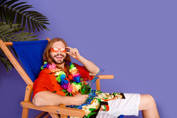 Full length photo of good mood man dressed shirt lay on deckchair drink cocktail touchiing sunglass isolated on purple color background