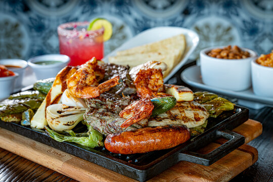 Parrillada de Sonora -Northern-style mixed grill with carne asada steak, mesquite chicken breast, chorizo links, spicy shrimp, Asadero cheese, cactus
paddles, grilled onions, and chile toreado