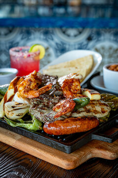 Parrillada de Sonora -Northern-style mixed grill with carne asada steak, mesquite chicken breast, chorizo links, spicy shrimp, Asadero cheese, cactus
paddles, grilled onions, and chile toreado
