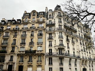Fototapeta na wymiar Parisian typical building facade on winter day, historical fashionable building in chic and rich quarter of the French capital city, EnrouteFrance