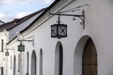 Antique outdoor wall lamps on the building, horizontal picture
