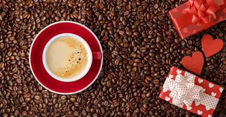 Romantic coffee beans background with red white cup of coffee, gift boxes and wooden hearts.