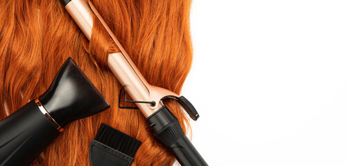 Long wavy red female hair, hair blow dryer, and Curling Iron on white isolated background....