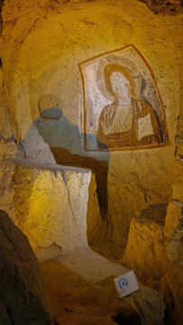 CAPPADOCIA, TURKEY - JANUARY 18, 2023: Deep within a Cappadocian cave, a Christian fresco paints a vivid tableau: saints and seraphim rendered in timeless hues.