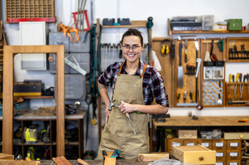 Portrait of a confident female carpenter standing in her workshop