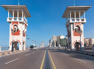 People walk the Stanley Bridge, popular landmark of Alexandria, Egypt - obrazy, fototapety, plakaty