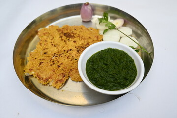 Makki Ki Roti and Sarson Ka Sag. It is Corn floor flat bread and  mustard greens curry respectively. Popular Punjabi food. Delicious Indian food. Makai ki roti and sarso ki sag.
