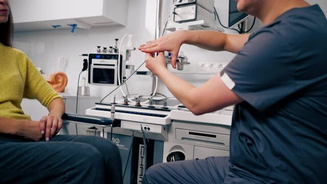 the ENT doctor consults the patient in the office of the clinic and tells about the possible consequences of the operation