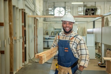 Carpenter man Portrait of Young black skin looking smile laugh to camera in workshop. Happy...