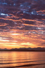 View of a lake at dusk with a mountain range in the background