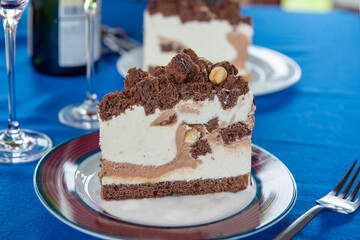 chocolate multilayer cake. A plate with a piece of delicious chocolate cake on a wooden table.