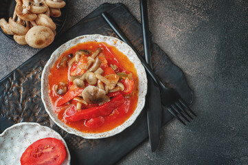 Lecho made of peppers, tomatoes and honey fungus mushroom . Home cooking for winter. Cold appetizer. Preparation for cooking the first course. Top view, flat lay, copy space