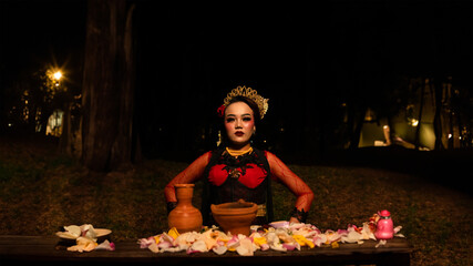 a female dancer performs a ritual that creates a magical and mystical atmosphere in front of flower...
