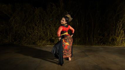 an Indonesian dancer looks full of enthusiasm and shows his courage to move and dance