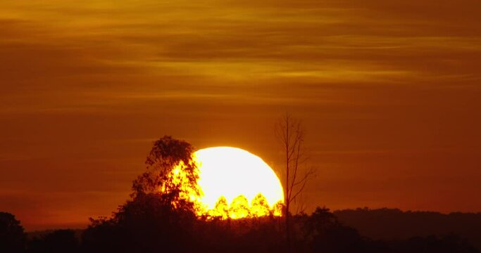 Big sun Timelapse Sunrise, close up of big sun rising through clouds. Beautiful nature background time laps.