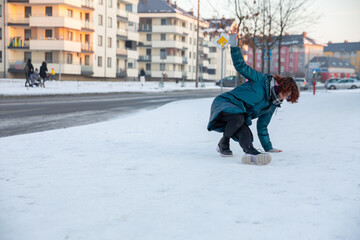 The girl slipped on the snow and fell.