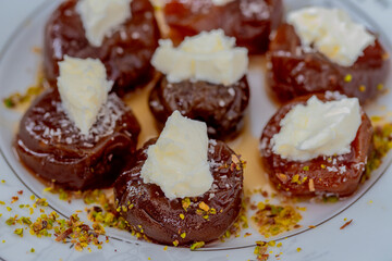 Traditional stuffed dried fig dessert with walnuts and cream, cooked with syrup (Turkish name: fig dessert with cream).​