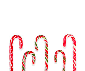 New Year's sticks candy canes with stripes on a white isolated background close-up
