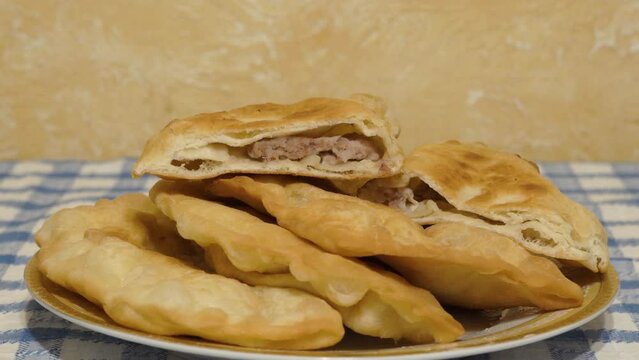 a plate of chebureks with meat, home-made juicy chebureks with meat filling
