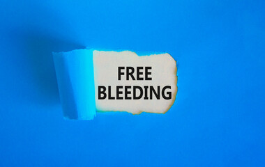 Free bleeding symbol. Concept words Free bleeding on beautiful white paper. Beautiful blue table...