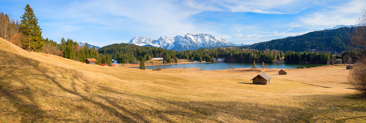 wide view over slope to lake Geroldsee and karwendel mountains in march