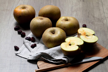 Pipping apples for compote on wooden board