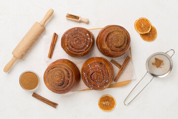Sweet homemade cinnamon rolls on concrete background, top view