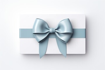 White greeting card or voucher tied with blue ribbon and bow on white background top view