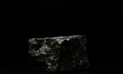 black natural stones on a black background for the podium