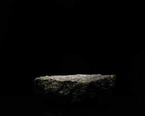 black natural stones on a black background for the podium