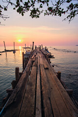 wooden pier at sunset in ko chang, thailand