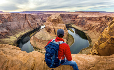 Hiker overlooking the canyon of horseshoe bend - Powered by Adobe