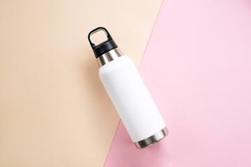 Reusable eco friendly sustainable water bottle on colour background. Copy space. Flat lay, top view. Zero waste, no plastic concept.