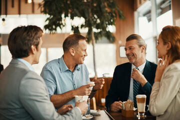 Business colleagues talking during a coffee break at a cafe