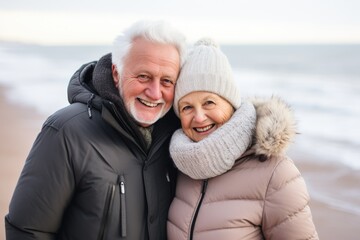 Portrait of a happy senior couple on the beach at winter