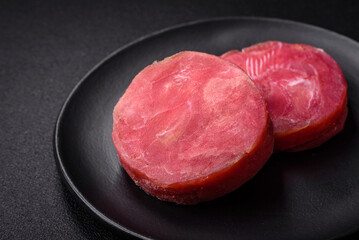 Round shape steaks of raw juicy tuna with salt and spices