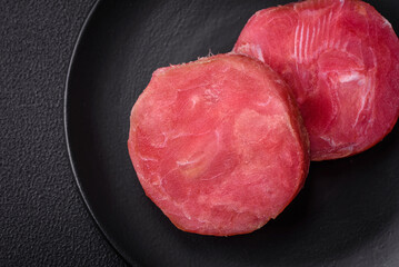Round shape steaks of raw juicy tuna with salt and spices