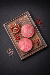 Round shape steaks of raw juicy tuna with salt and spices