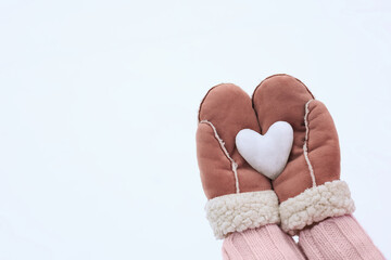 a snow heart in your hands in soft mittens. Soft Focus