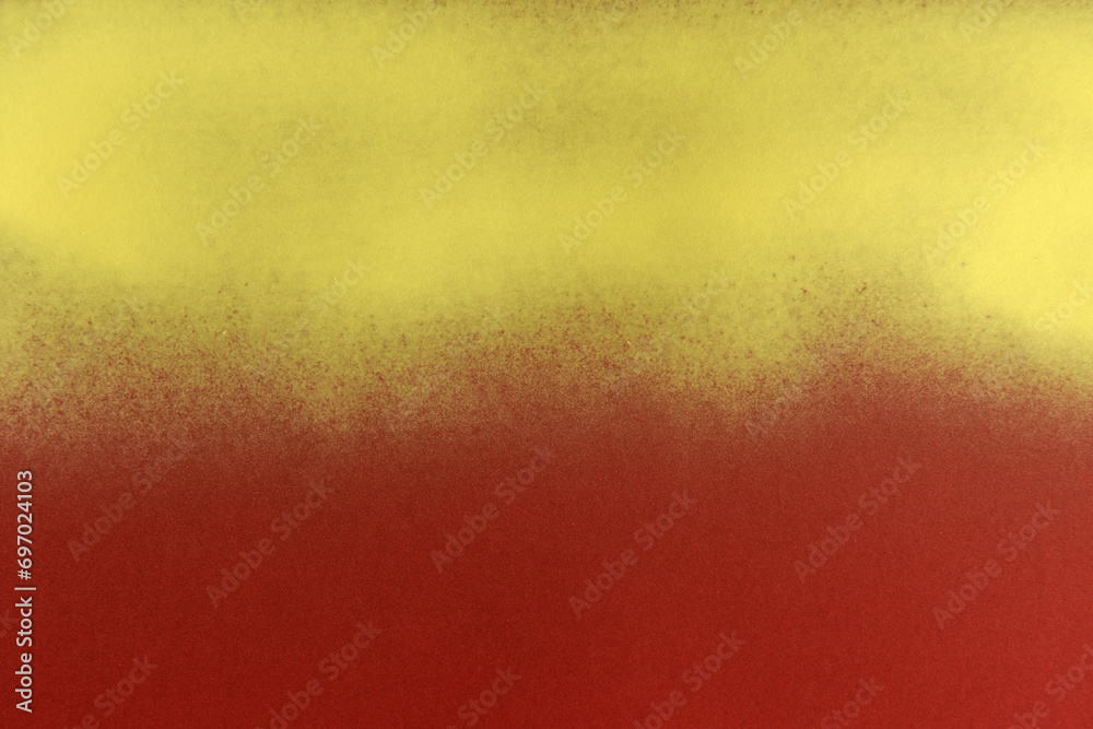 Wall mural yellow spray paint on red paper background