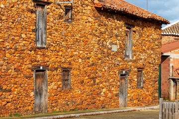 Houses, windows and facades built with red limestone typical of the La Maraguatería region in Castilla y León, Spain