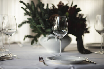 Table set before Christmas. Restaurant, white tablecloth and dishes.