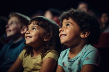 Two youngsters immersed in a captivating movie experience at the theater