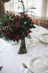 Table set before Christmas. Restaurant, white tablecloth and dishes.