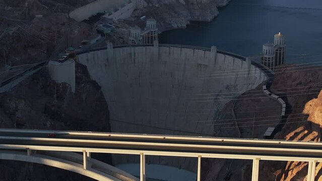 Hoover Dam on the Colorado River straddling Nevada and Arizona at dawn from above. Aerial view of Hoover Dam and the Colorado River Bridge