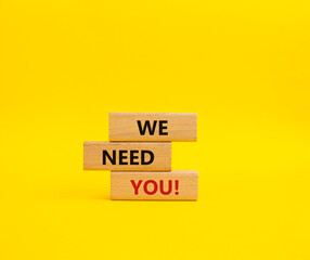 We need you symbol. Concept words We need you on wooden blocks. Beautiful yellow background. Business and We need you concept. Copy space.