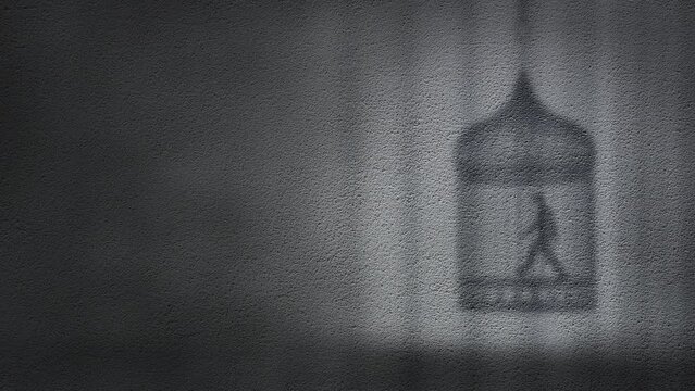 A man thinking walking in a cage on wall shadow silhouette. Depicting an abstract mood concept of human locked up in their thinking cage alone in a loop.